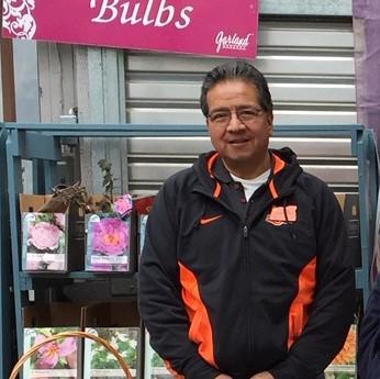 Man standing next to a display of flower bulbs - Pop Up Plant Clinic