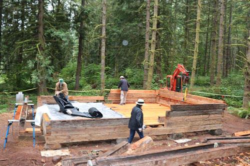 The Molalla Log House is being reassembled near a walking trail by newly constructed ponds  t Hopkins Demonstration Fore