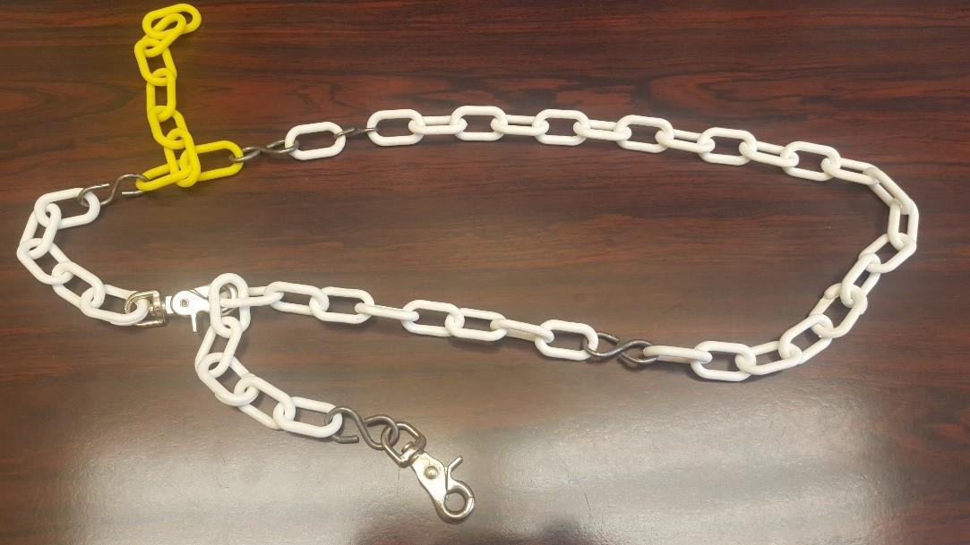 A plastic chain is strapped around the waist to provide a place to attach a metal scabbard.