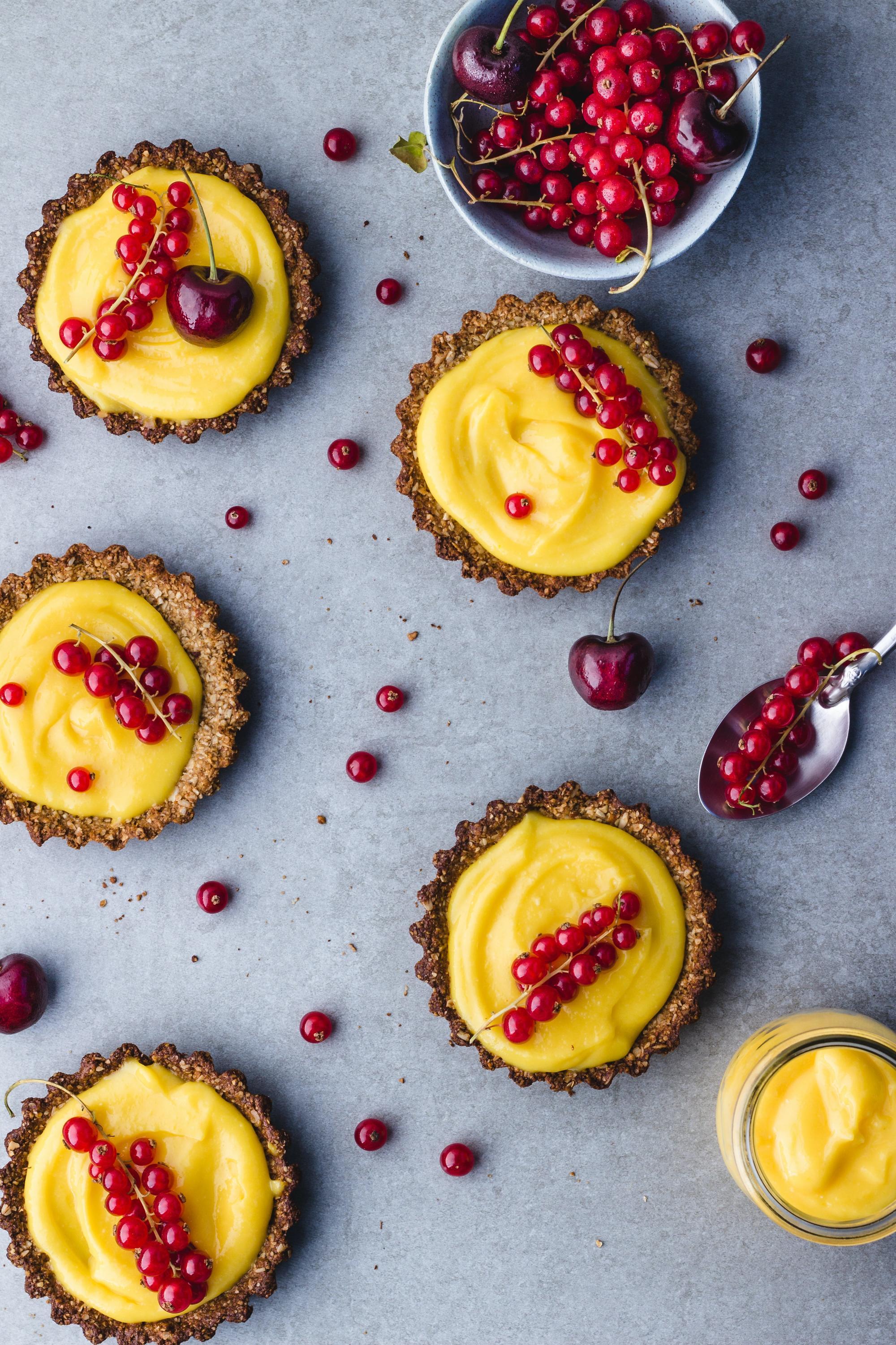 Tarts with lemon curd and red berries.