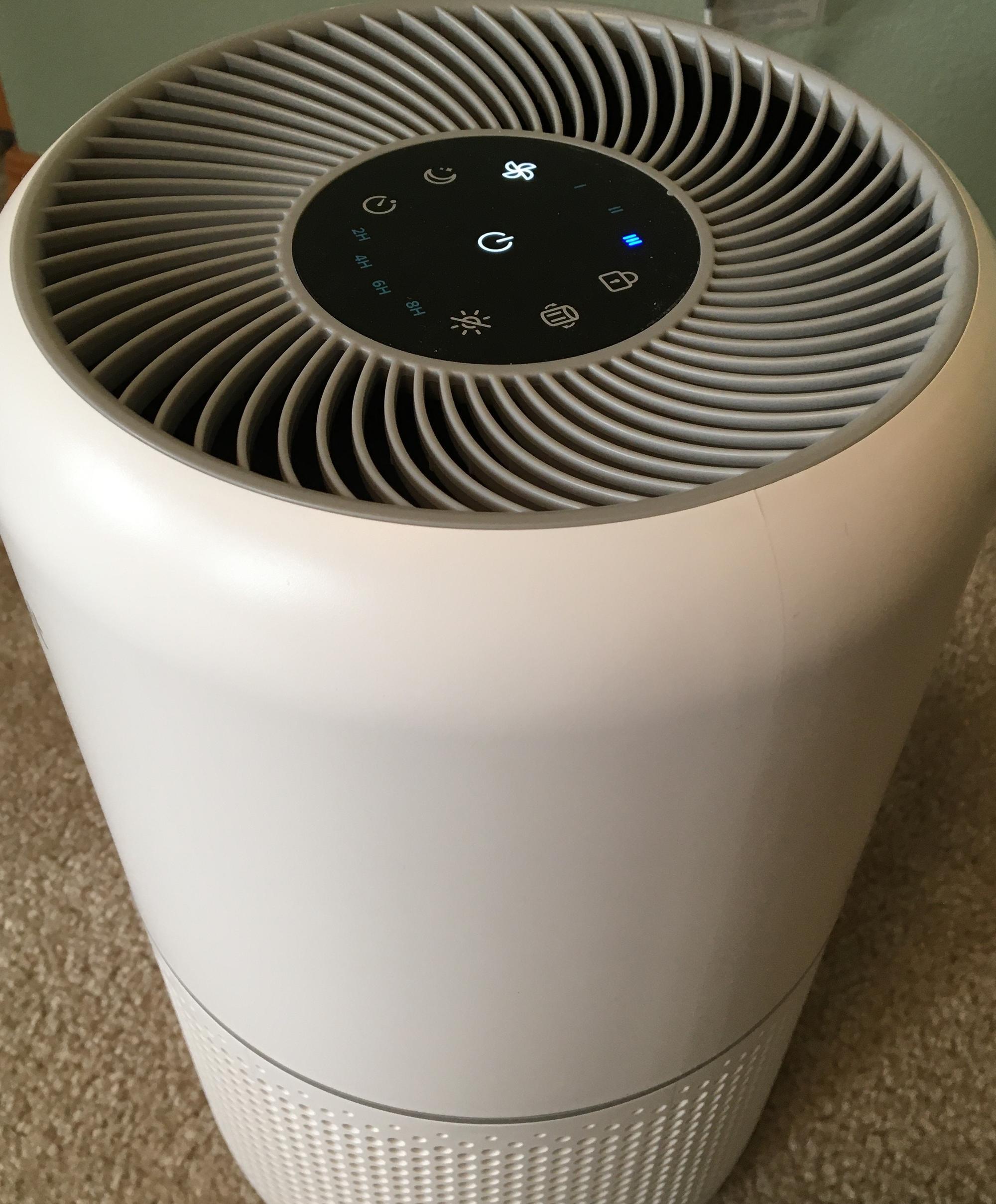 Portable indoor air cleaner shown operating at highest speed