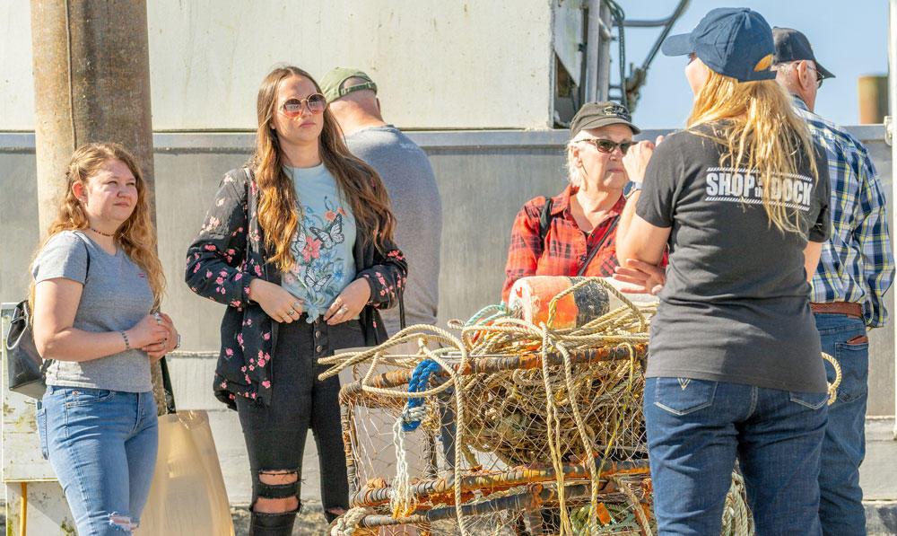 Emily Rice (from left), Kira Saling and Karen Kone learn about the types of sea creatures that are caught by Newport's f