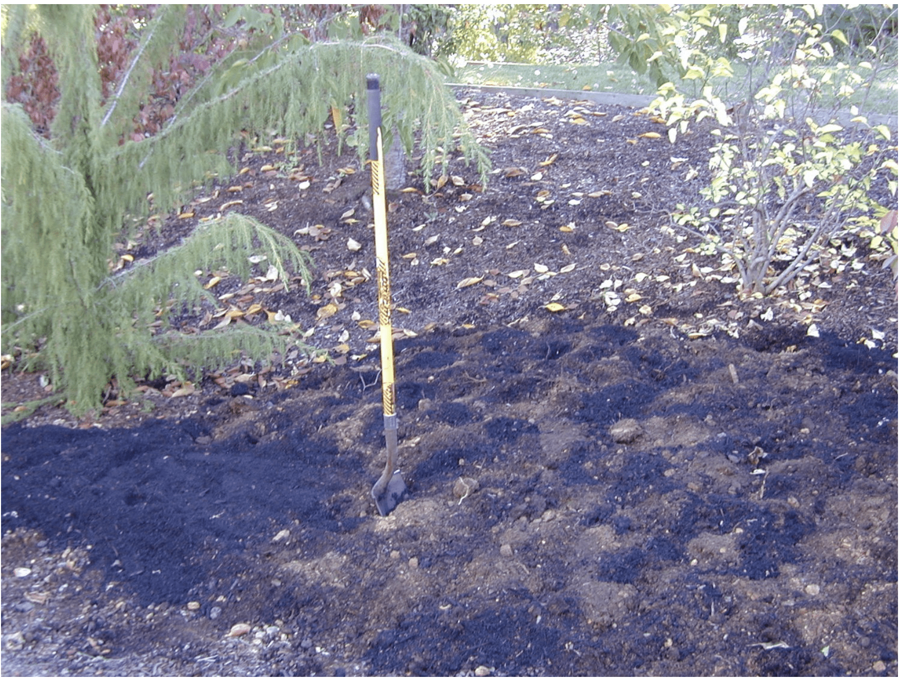 compost mixed into soil for a landscape bed