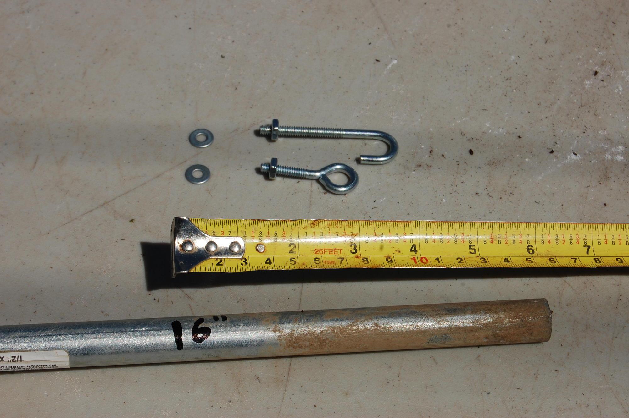 hook and eye closures next to measuring tape and a hoop end