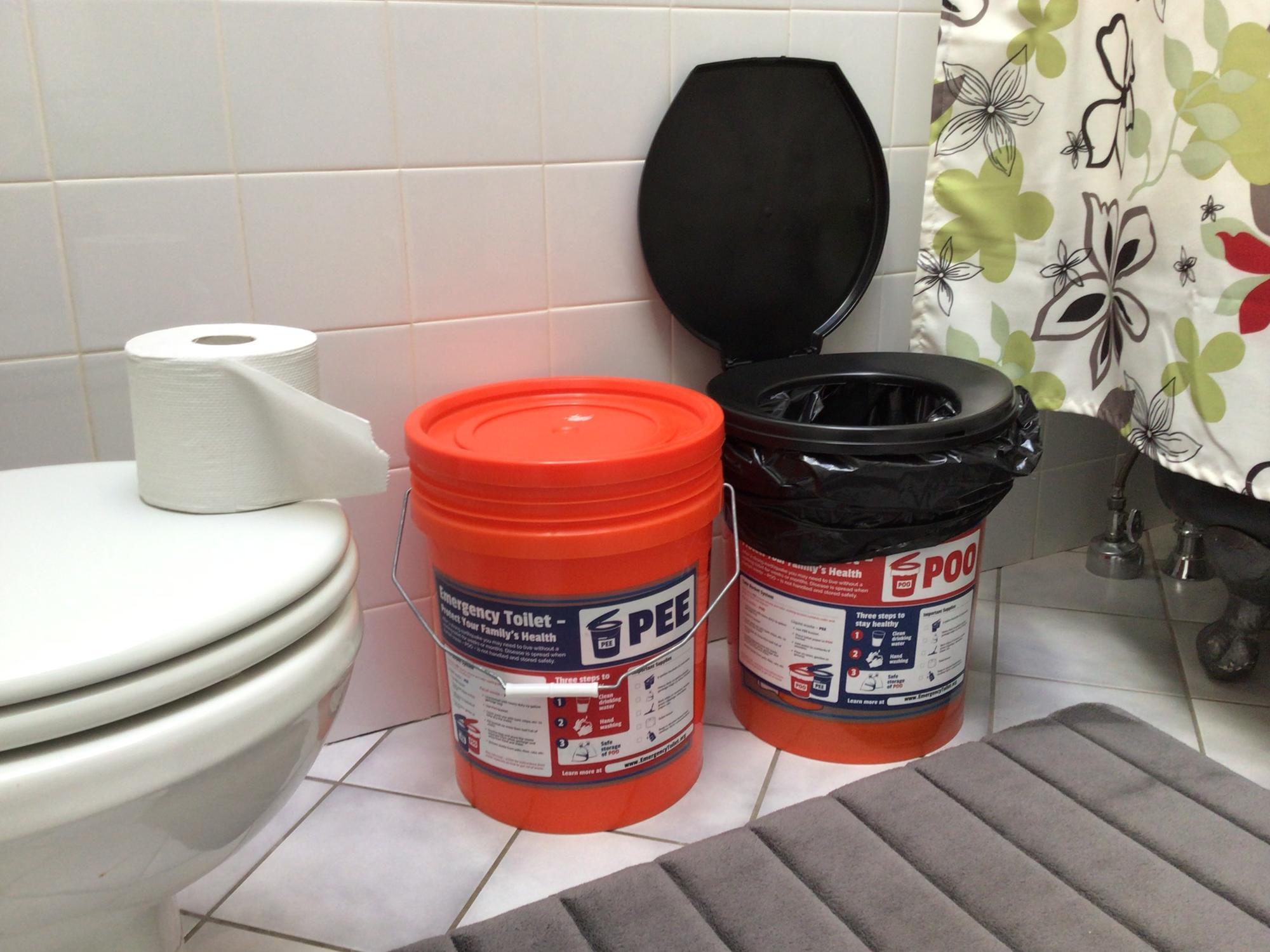 pee and poo buckets on a bathroom floor