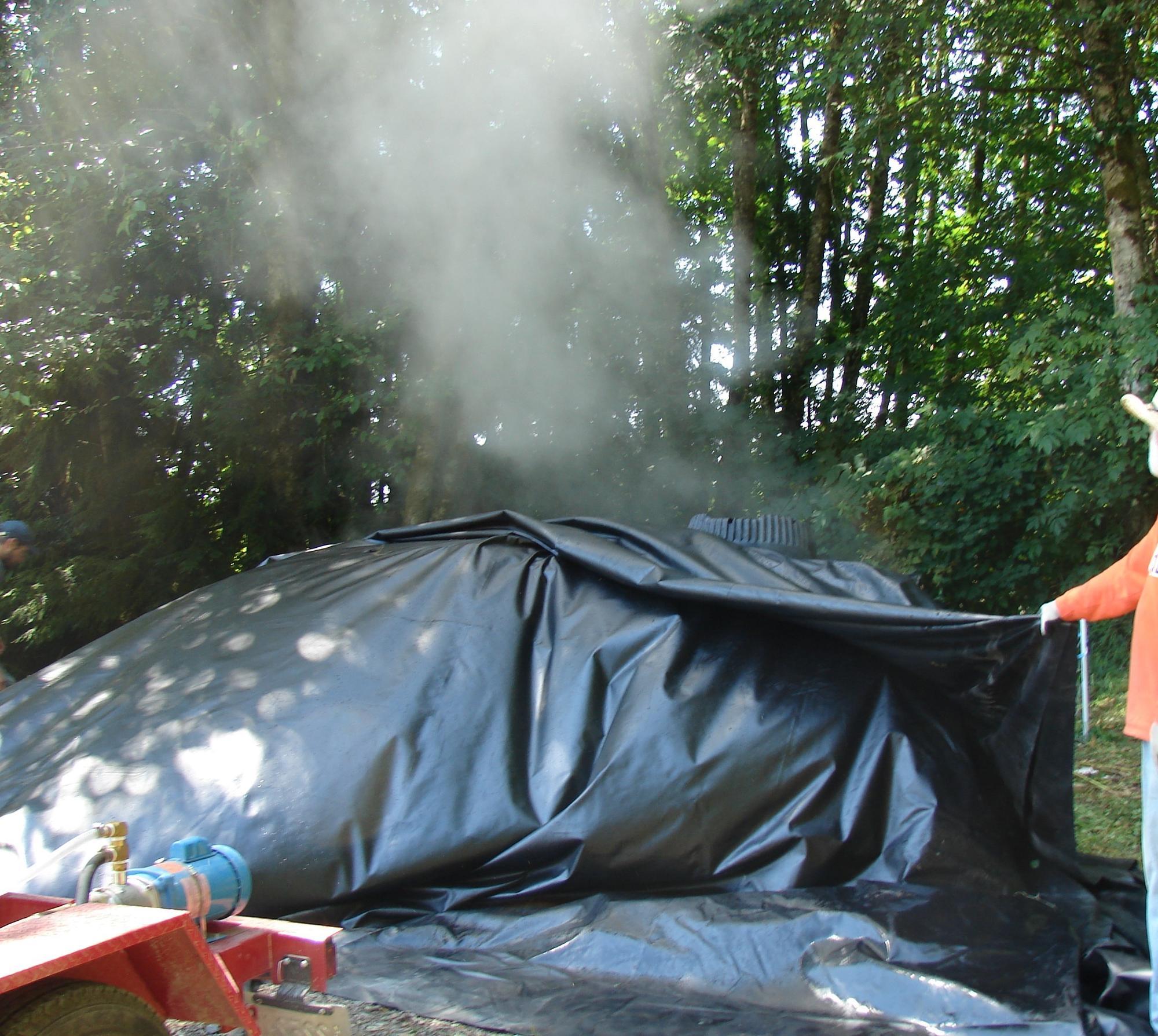 steam from plastic-covered mound