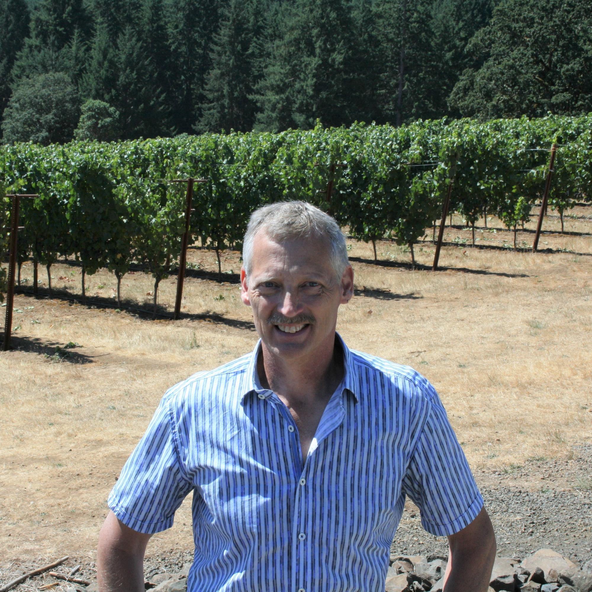 Paul Schreiner, USDA-ARS researcher standing near vineyard