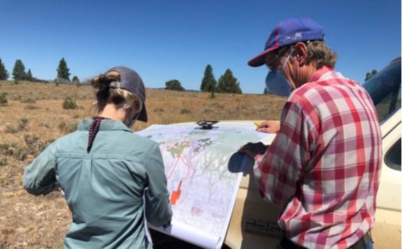 A landowner and a U.S. Fish and Wildlife Service staff member discuss the location of fuel breaks within the area.