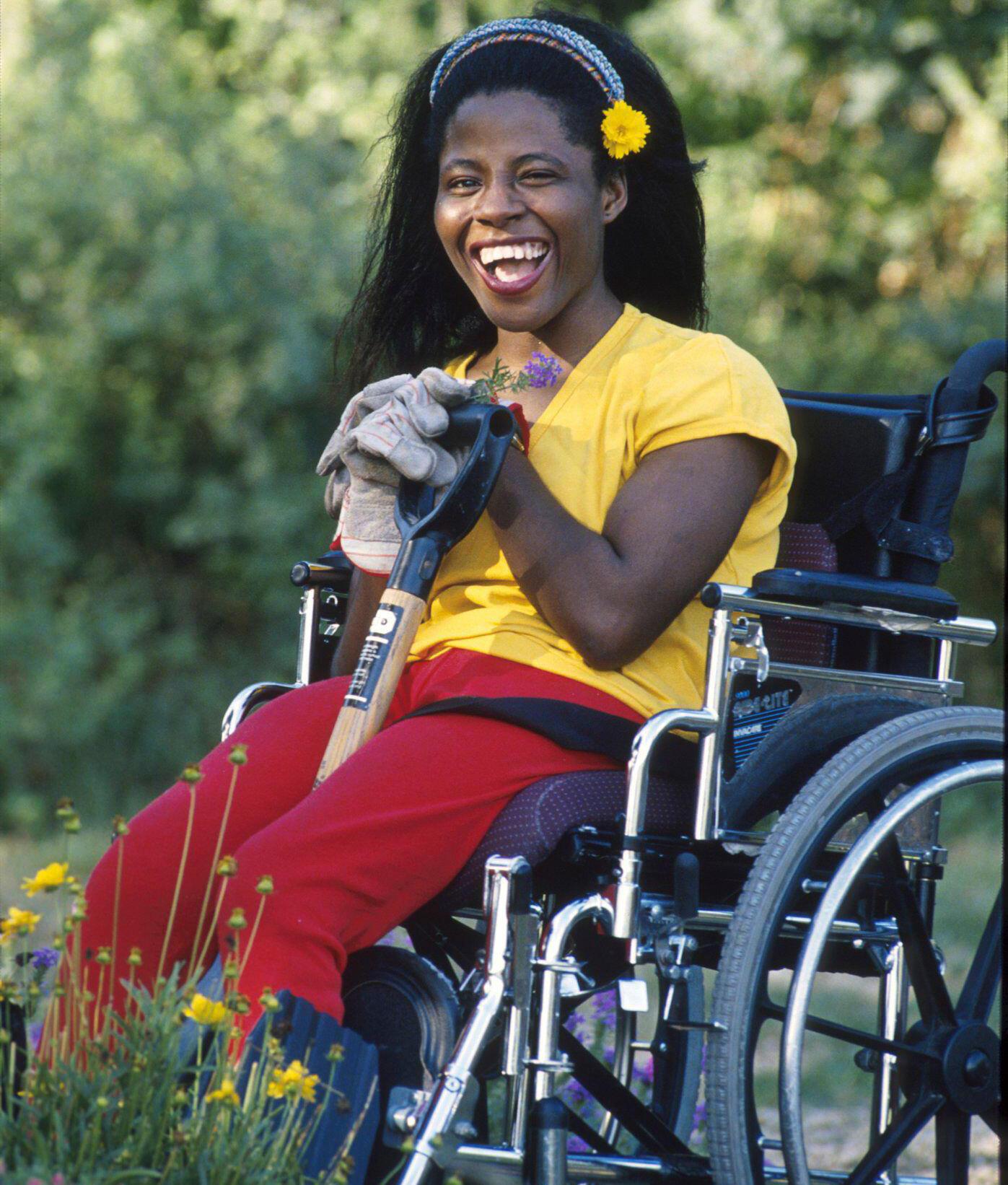 A person in a wheelchair working in the garden