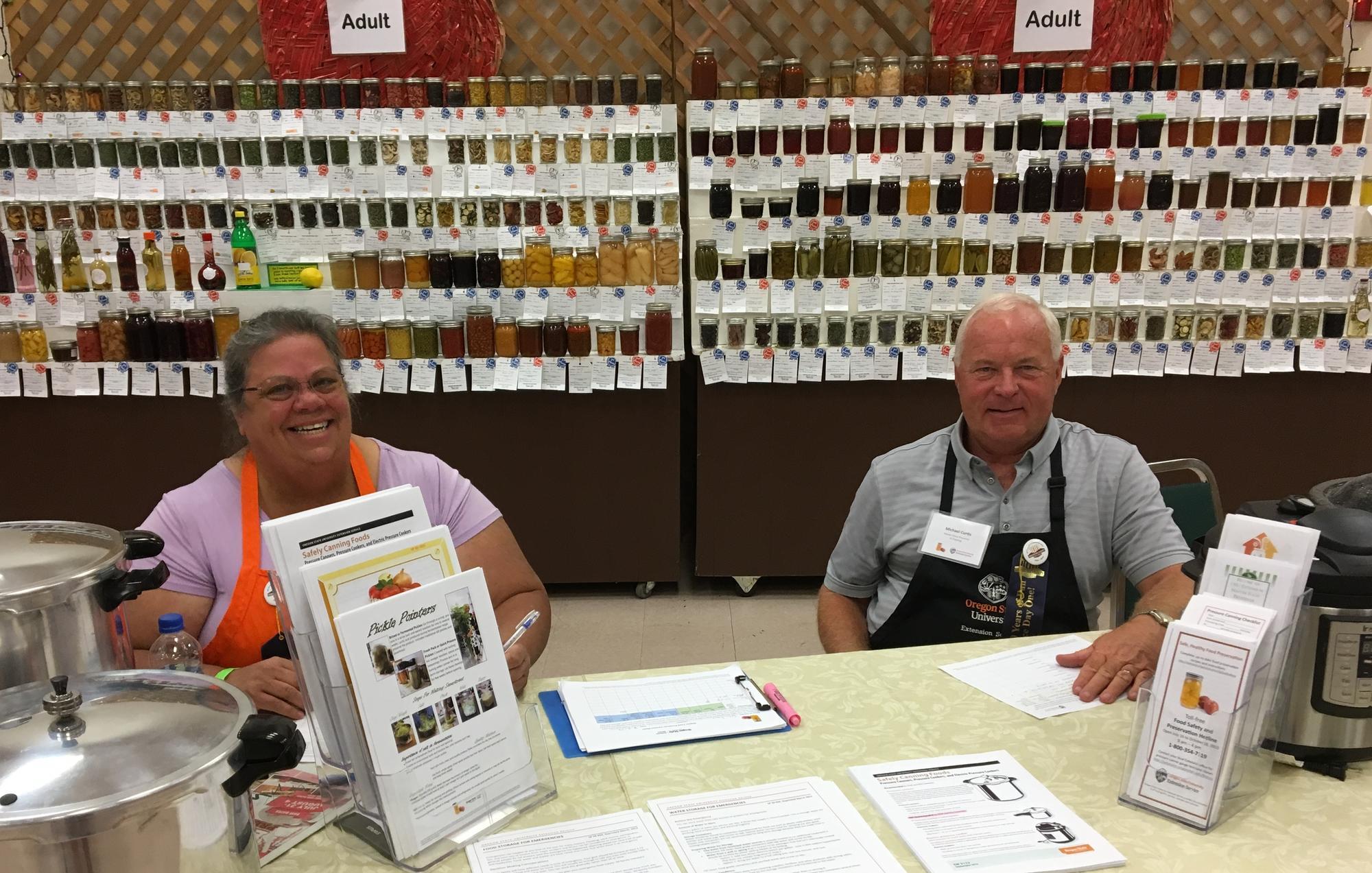 MFP volunteers answering questions at the food preservation display at the Deschutes County Fair