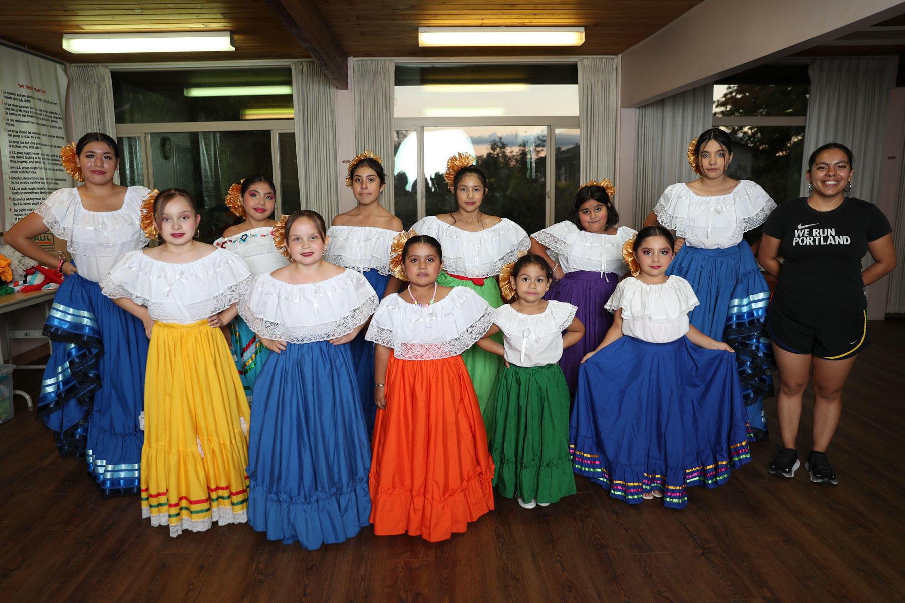 Baile Folklórico dancers pose for a group photo.