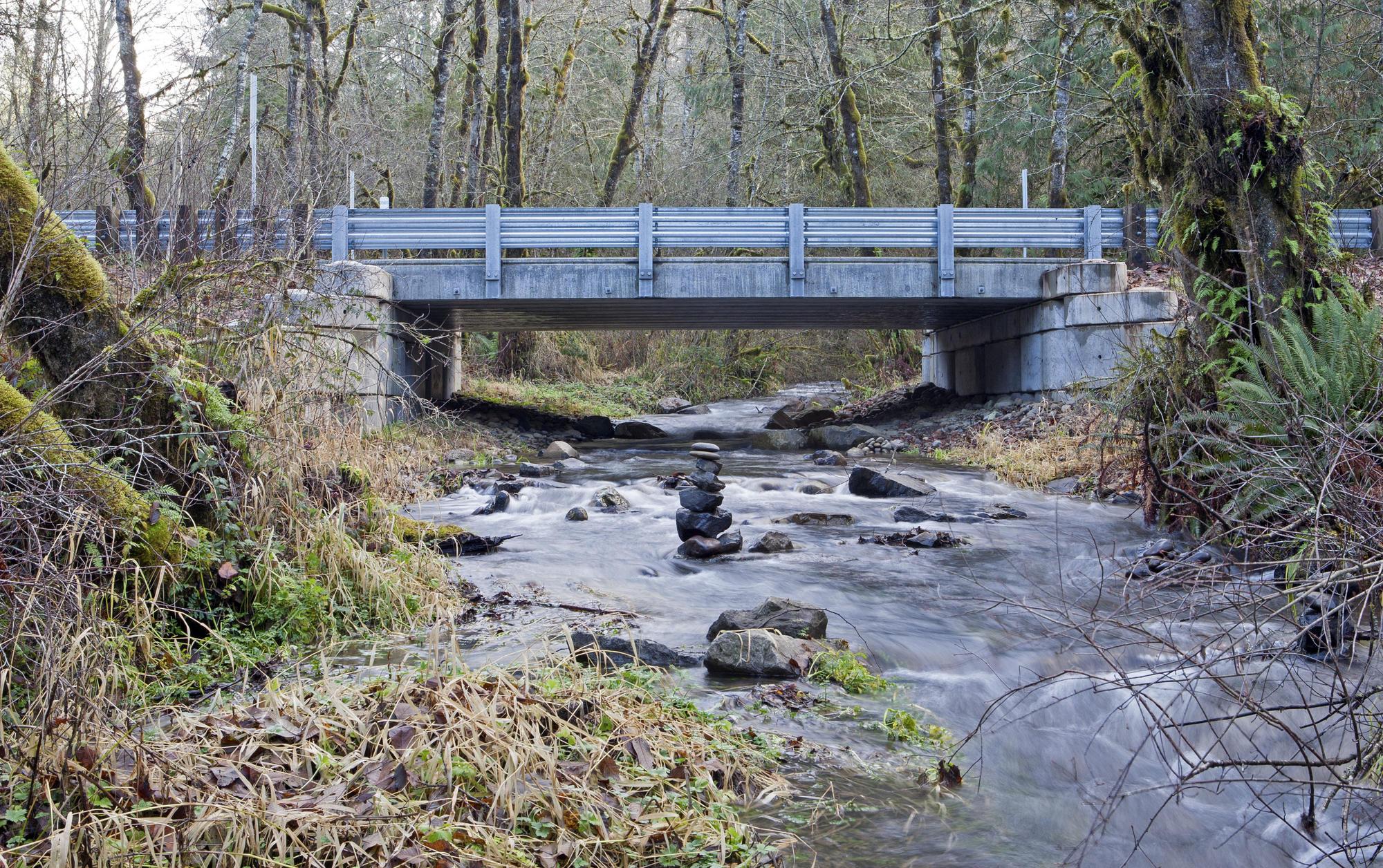 Creek with bridge in place, replacing previous culverts.