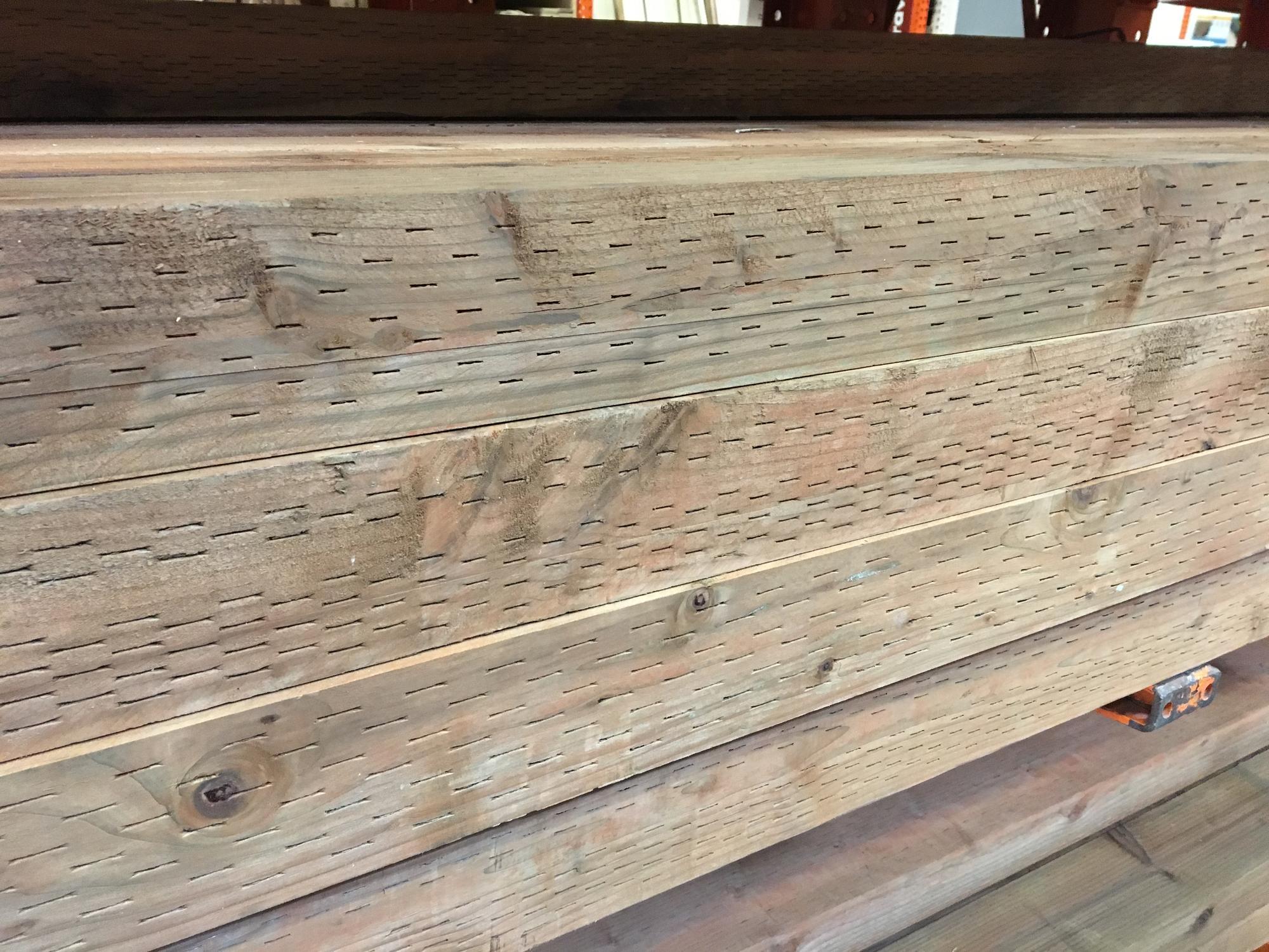 horizontal stack of pressure treated wood