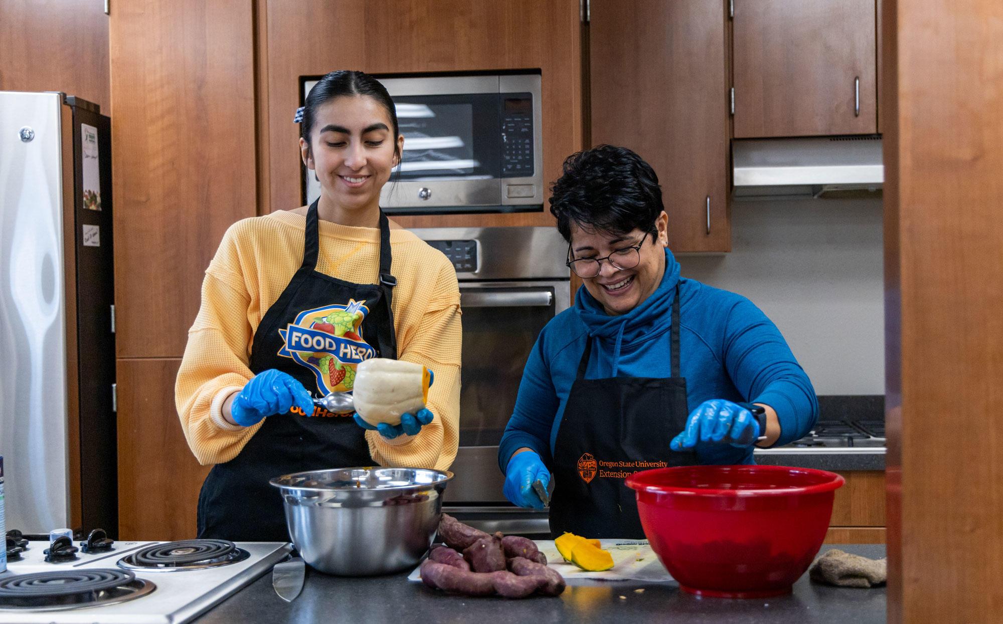 OSU Extension nutrition educators Iris Carrera and Itzel Arizmendi prepare recipes in the Linn County office's demonstration kitchen with winter vegetables procured from local farmers.