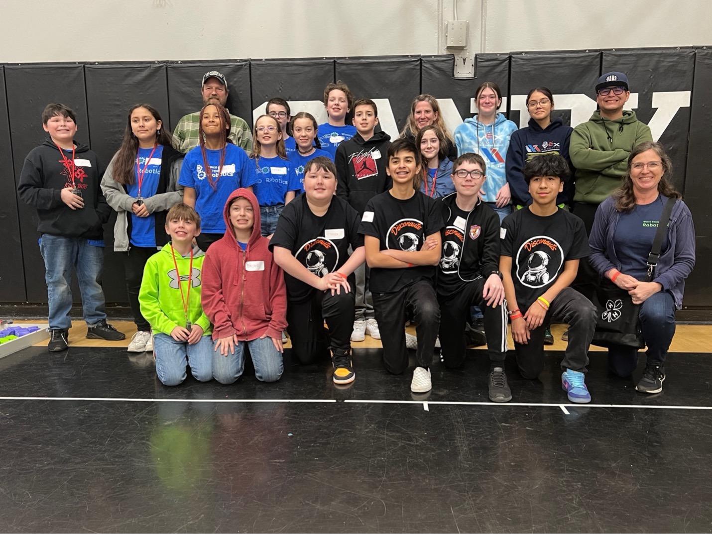 Wasco County 4-H Robotics team members pose for a group photo at the VEX IQ Robotics Oregon State Championship with teen mentors and Lu Seapy.