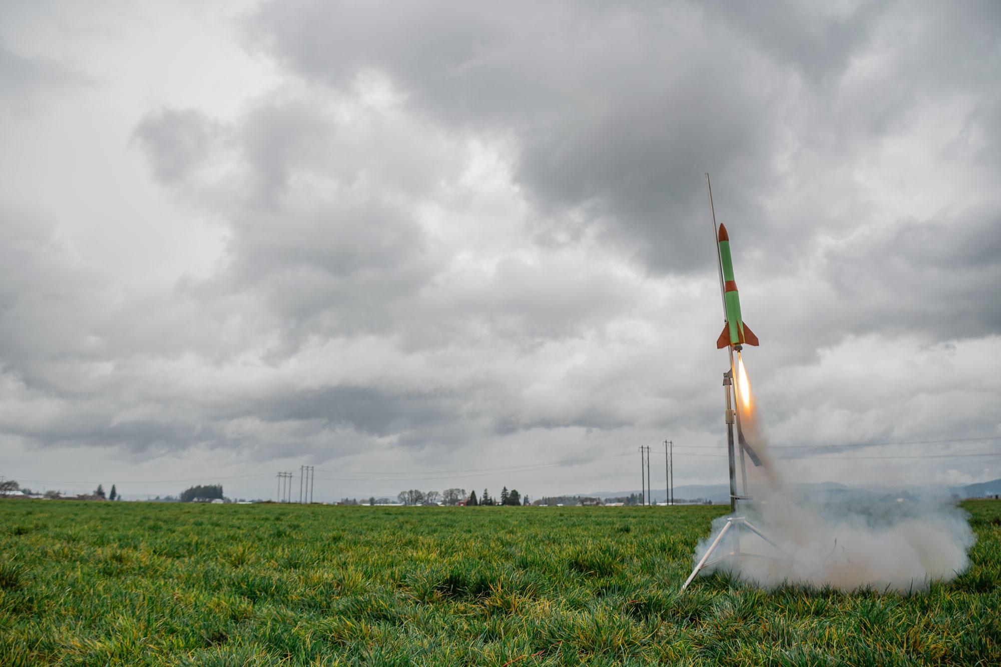A rocket designed by the David Douglas High School Rocket Club lifts off.
