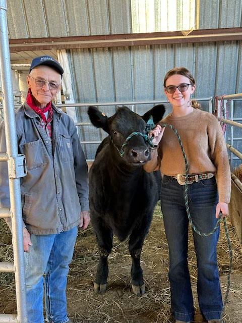 Randy Kessler, owner of Kessler Angus in Milton-Freewater, poses with Mickenzie Marks and her heifer, Lassie.