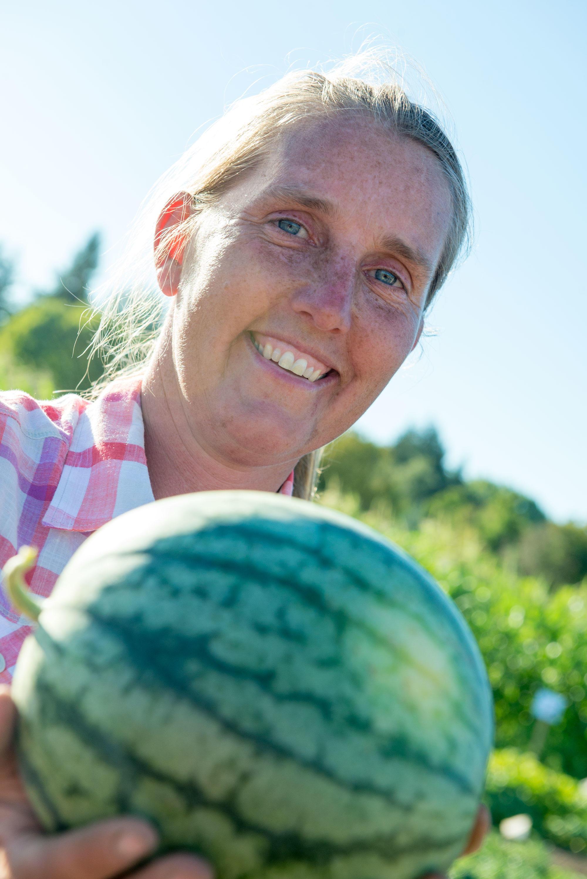 Heidi Noordijk smiles while holding a small watermelon.