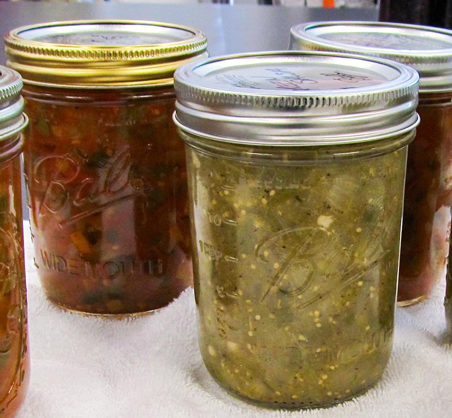 Jars of homemade green and red salsa.