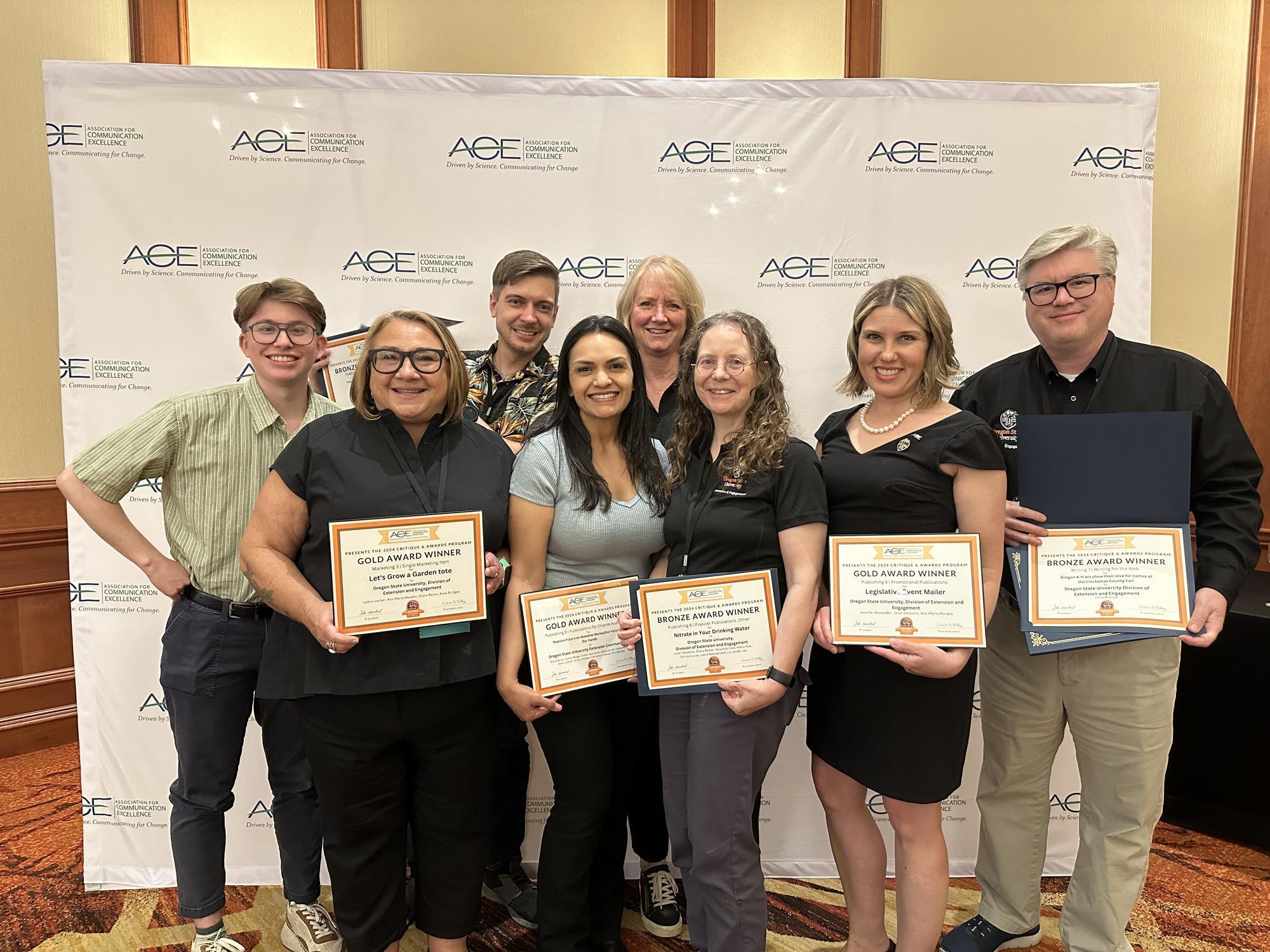 Members of the OSU Extension Communications office (from left) Henry Carnell, LeAnn Locher, Alan Dennis, Diana Reyes, Ann Marie Murphy, Janet Donnelly, Jennifer Alexander and Chris Branampose with awards at the ACE Conference in Salt Lake City.