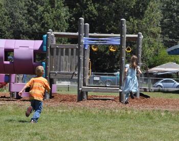 two kids run to playground