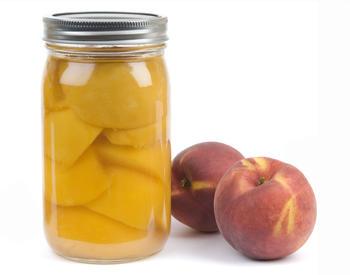 Fresh peaches and a jar of canned peaches. Image for OSU Extension Home Food Safety and Preservation Program