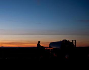 Gilliam County farmer drives a tractor at sunset.