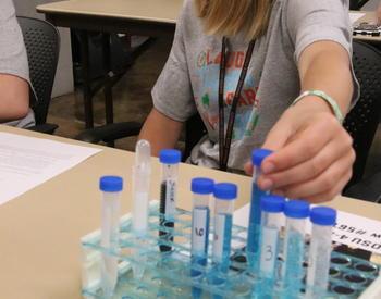 4-H kid working on a colormetric assay.