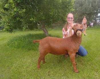 McKenzie Shelden poses with her Boer goat.