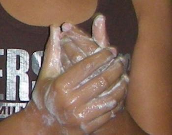 A close-up view of hands lathered up with soap.