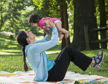 Mother holding baby in park