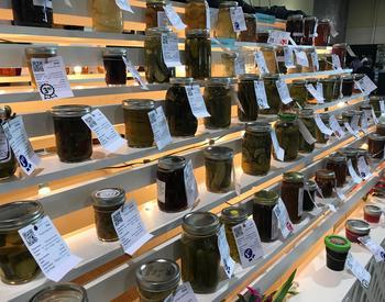Dozens of preserved food entries with tags attached sit on shelves at the 2017 Oregon State Fair.
