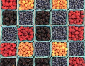 Containers of blackberries, raspberries, and blueberries.