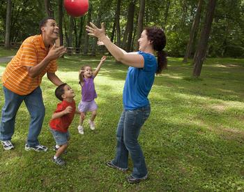 parents playing ball with children