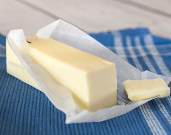 A stick of butter on a dishcloth.