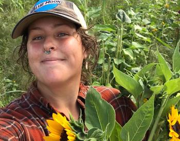 Picture of Shelby Lierman, Bullfrog Blooms Farm, with sunflowers in the foreground