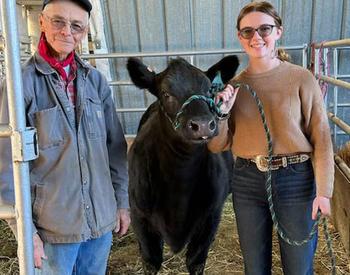 Randy Kessler, owner of Kessler Angus in Milton-Freewater, poses with Mickenzie Marks and her heifer, Lassie.
