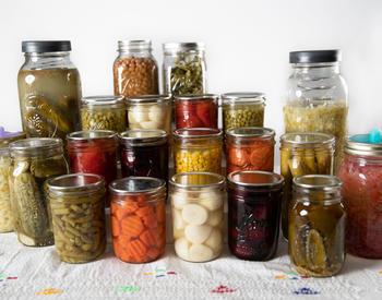 Canned vegetables displayed on a table with a white background.