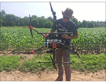 Dr. Jan van Aardt holds a drone with research-grade sensors on it for use in precision agriculture research.